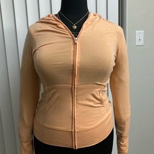 orange or peach jacket with thumb holes 62% polyester 33%cotton 5%spandex